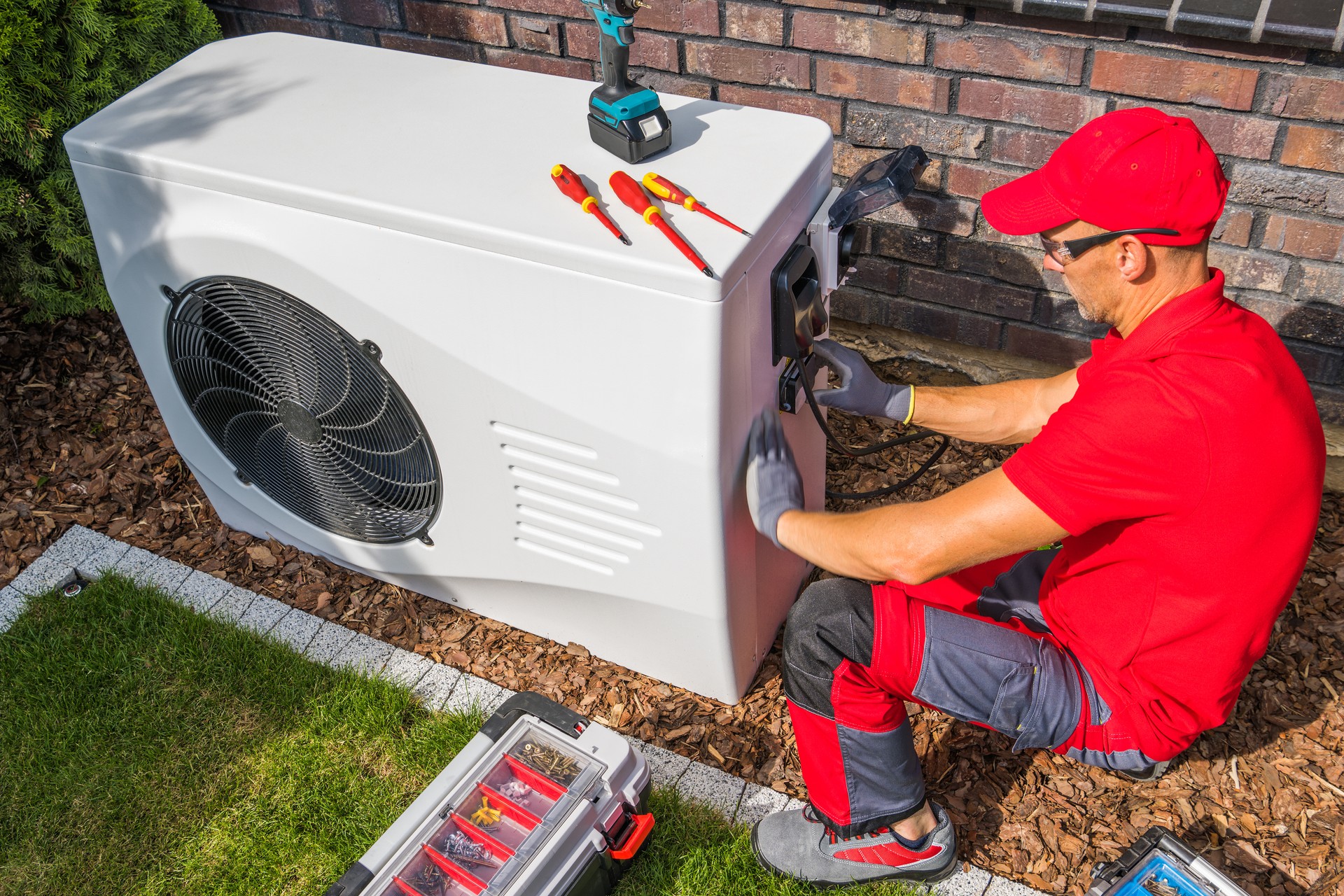 Technician Repairing Heat Pump Unit